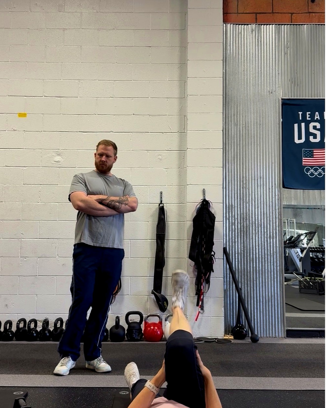 Zachary Nance coaching a client through a strength training session in a gym